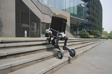 Wheeled-legged robot carrying a parcel up outdoor stairs